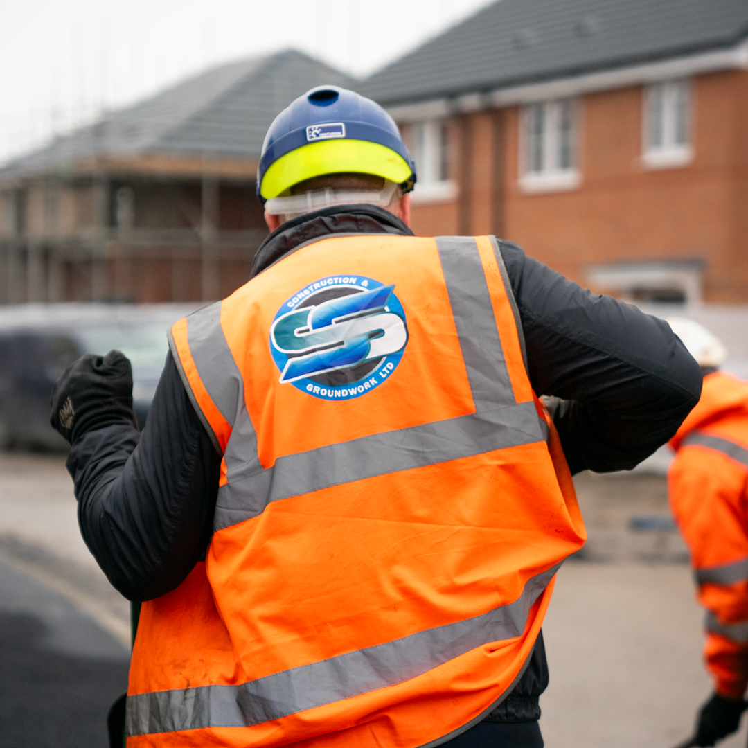 SS Construction operative in branded hi-vis on a live housing development